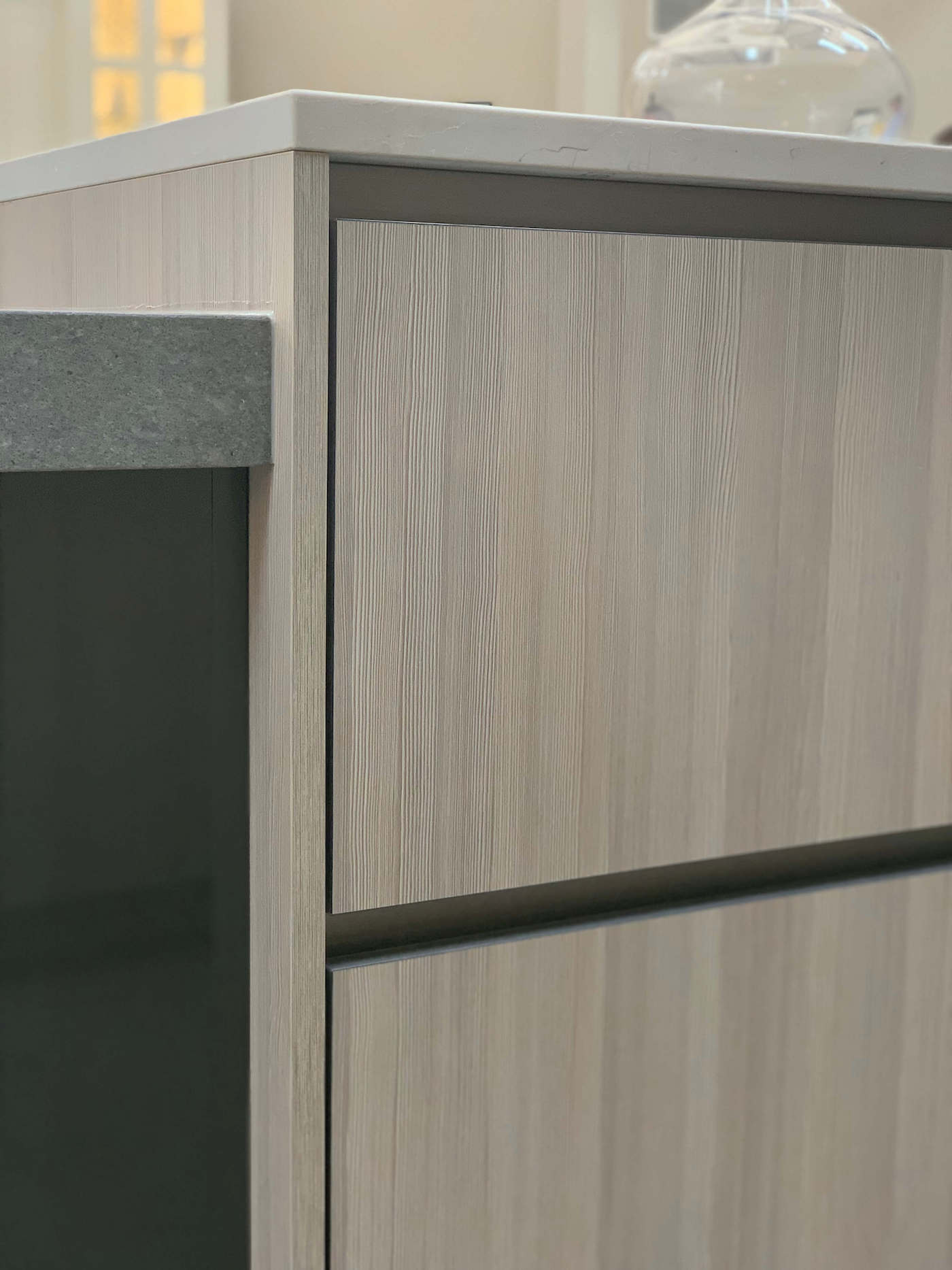 The GOLA channel system allows for a streamlined design free of cabinet hardware. Seen here, the system has been incorporared into a display at the Beck/Allen Cabinetry showroom in St. Louis, MO.