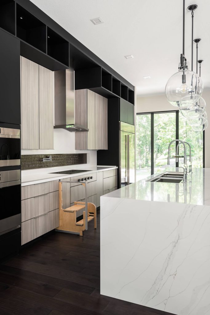 Step stools fold out of cabinets for easy access to storage